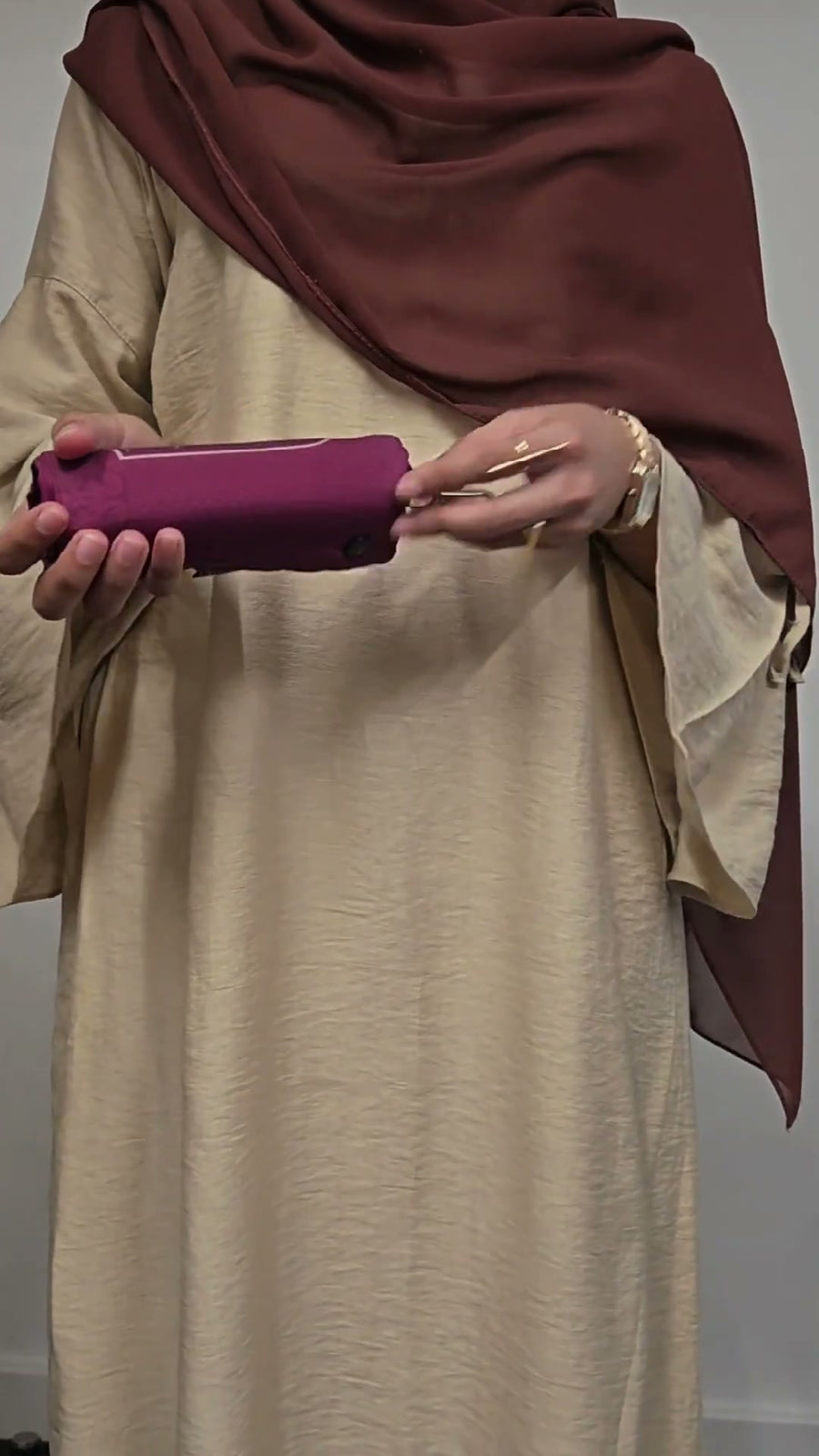 Unrolling the burgundy Muzura prayer mat